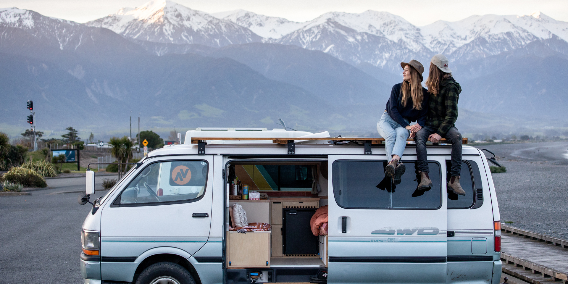 Campervan parked up in a scenic New Zealand spot, promoting freedom camping and van life.