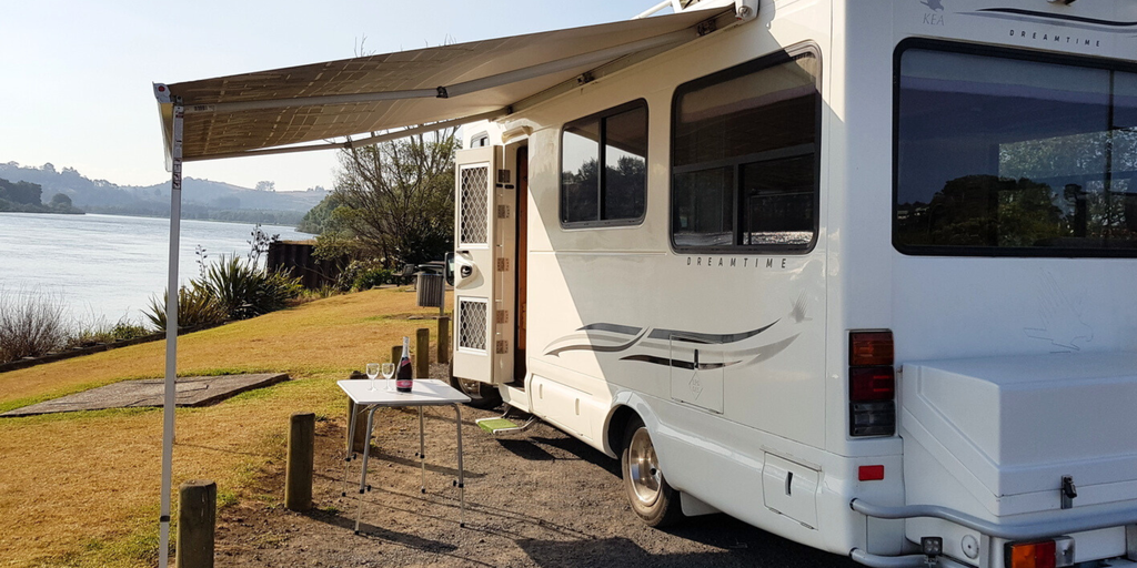 Campervan parked up at scenic campsite, ready for a long weekend getaway.