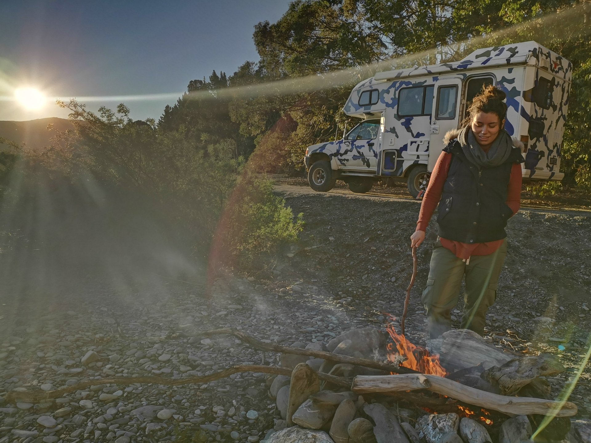 Snowy campsite with a pitched tent and winter camping gear.