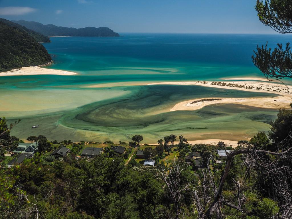Golden sands and turquoise waters meet lush native bush in Abel Tasman National Park.