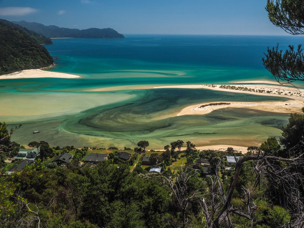 Golden sands and turquoise waters meet lush native bush in Abel Tasman National Park.