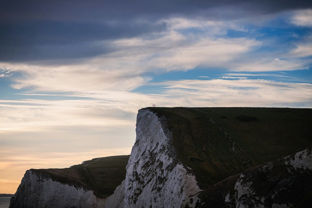Campervan overlooking Dorset coast. Camping holiday on the Jurassic Coast, South West England.