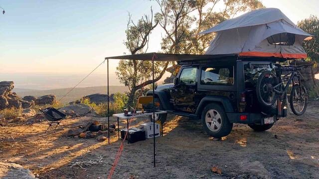 A rooftop tent set up overlooking the mountains