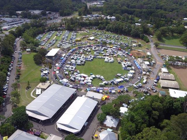 Caravan parked up at a scenic camping spot, mountains in the background.