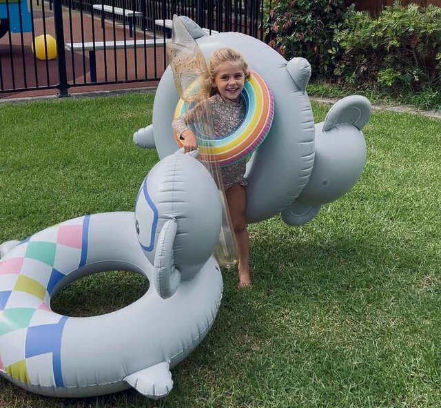 A child carrying pool toys