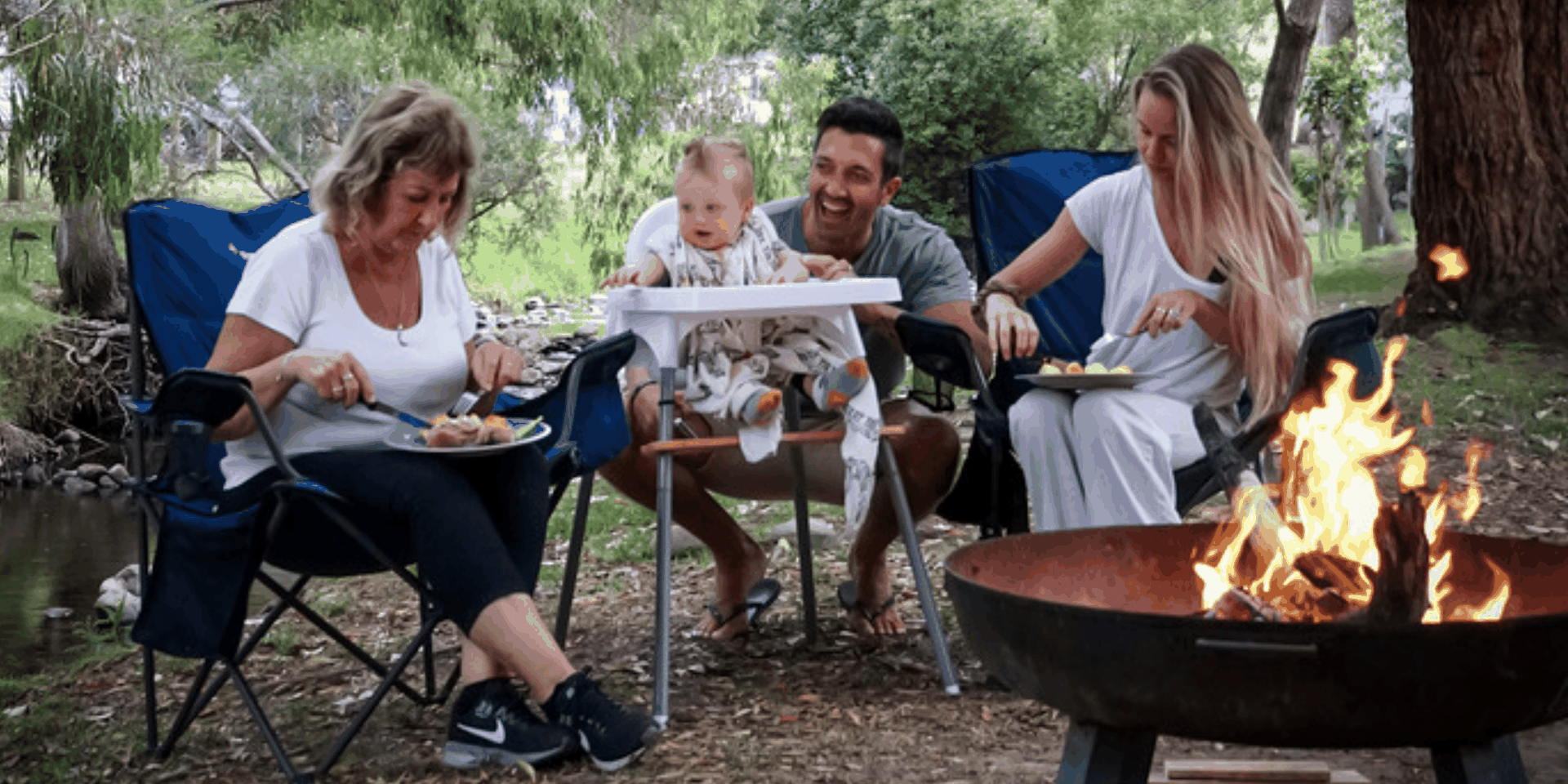 Family in front of campervan at Great Ocean Road lookout, ocean views behind 'em.
