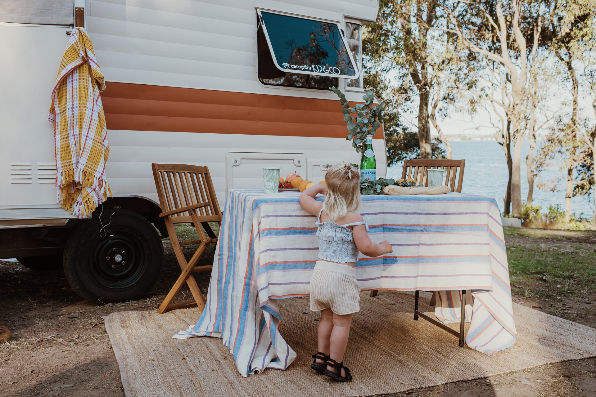 Luxury caravan with Kip&Co makeover parked at sunny campsite, ready for a spring getaway.
