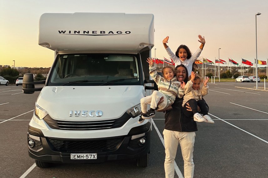 young family in front of a van