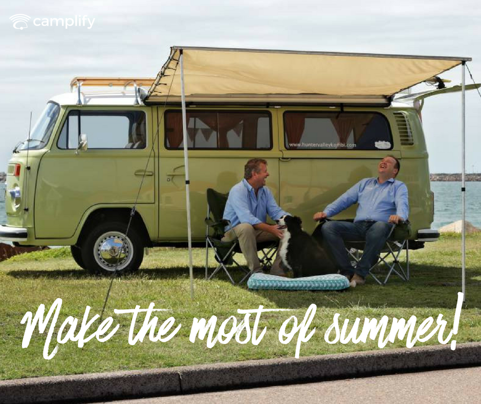 Couple toasting marshmallows at a campsite, campervan parked nearby. Summer camping vibes!