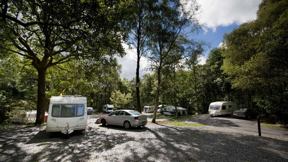 Couple campin' in the Aussie bush, enjoyin' a quiet off-season getaway.