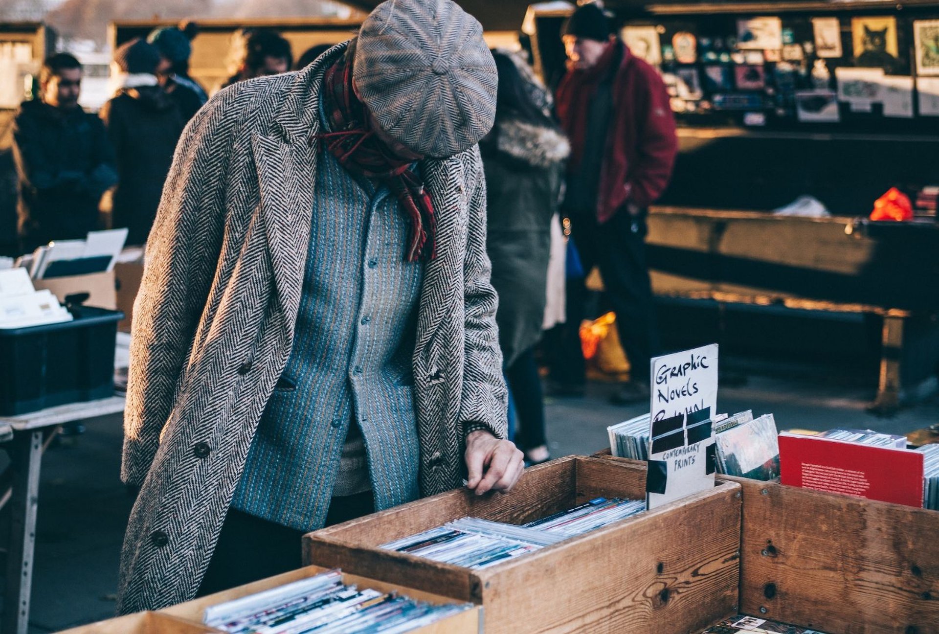 Mann stöbert auf einem Flohmarkt