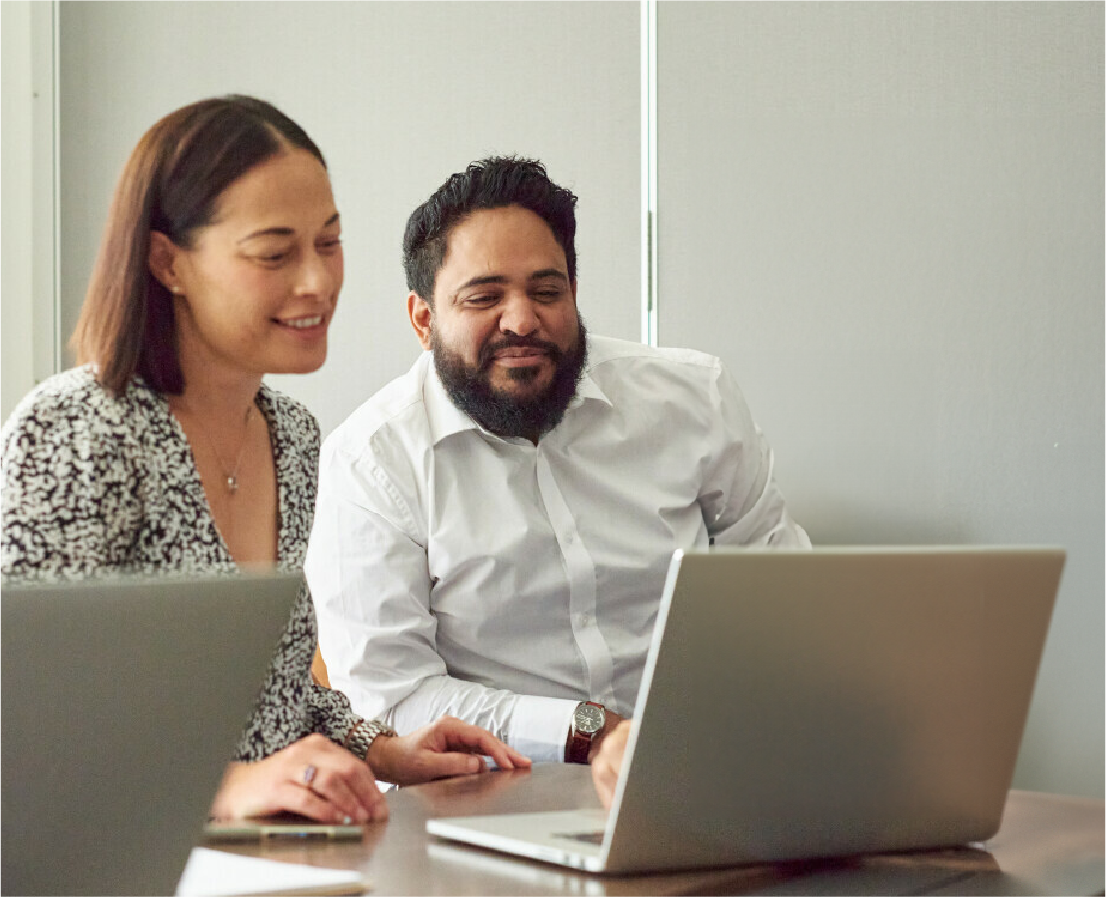 Two people looking at a laptop