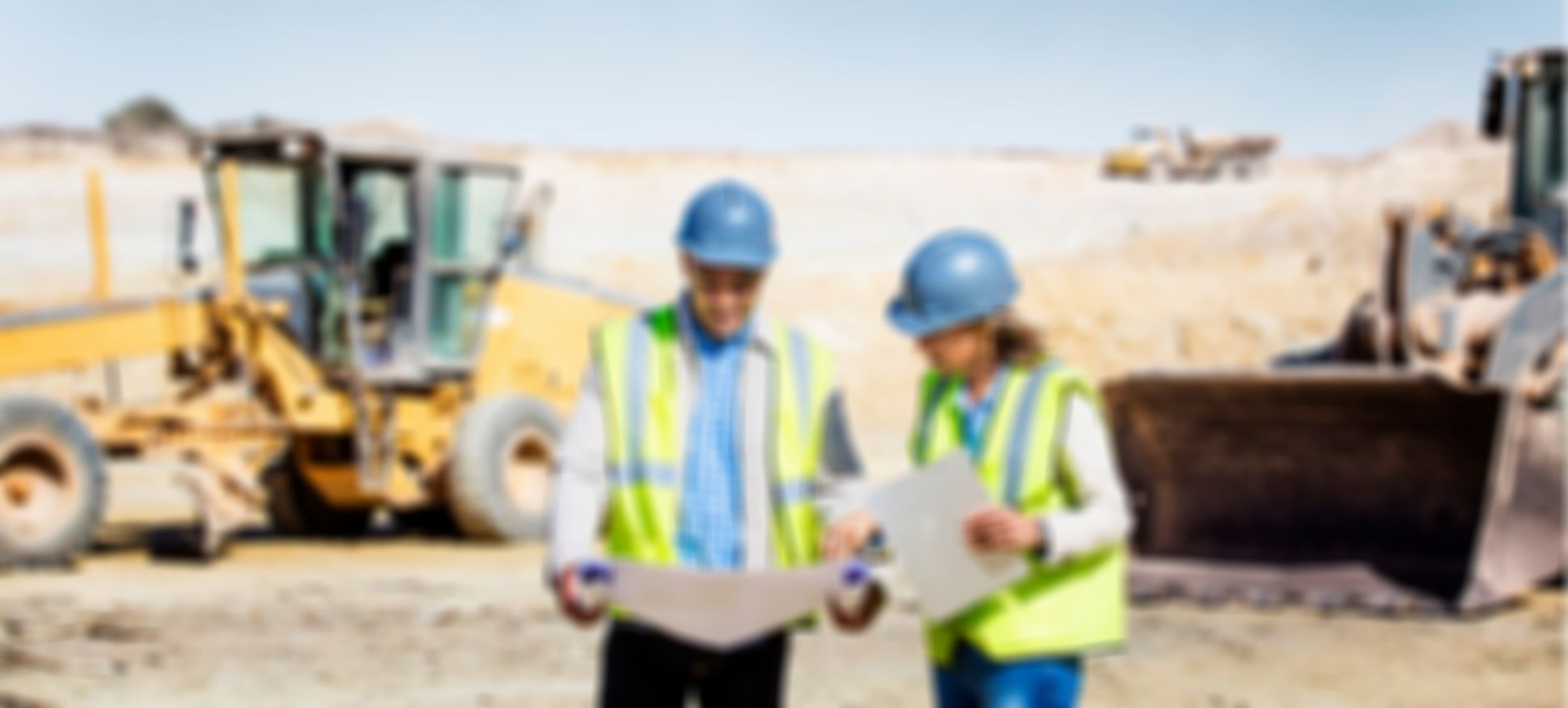 two people in high visibility work-wear on job site