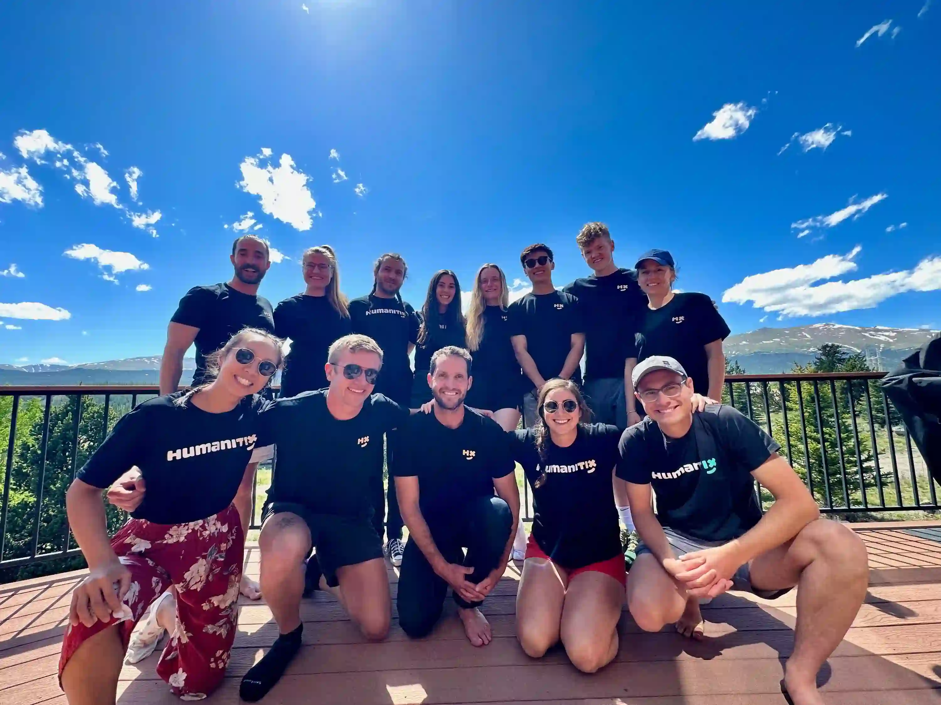 Humanitix Denver team against a bright blue sky