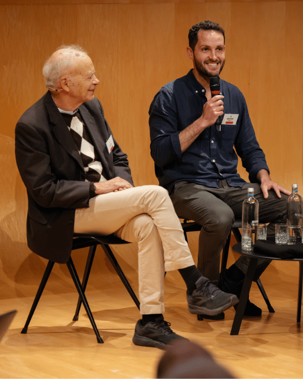 Peter Singer and Adam McCurdie speaking at the Profit for Good conference
