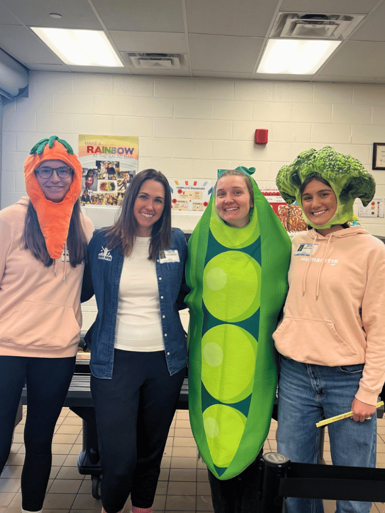 Kierstin, Avery and Belle dressed as vegetables with Chef Ann Foundation staff member