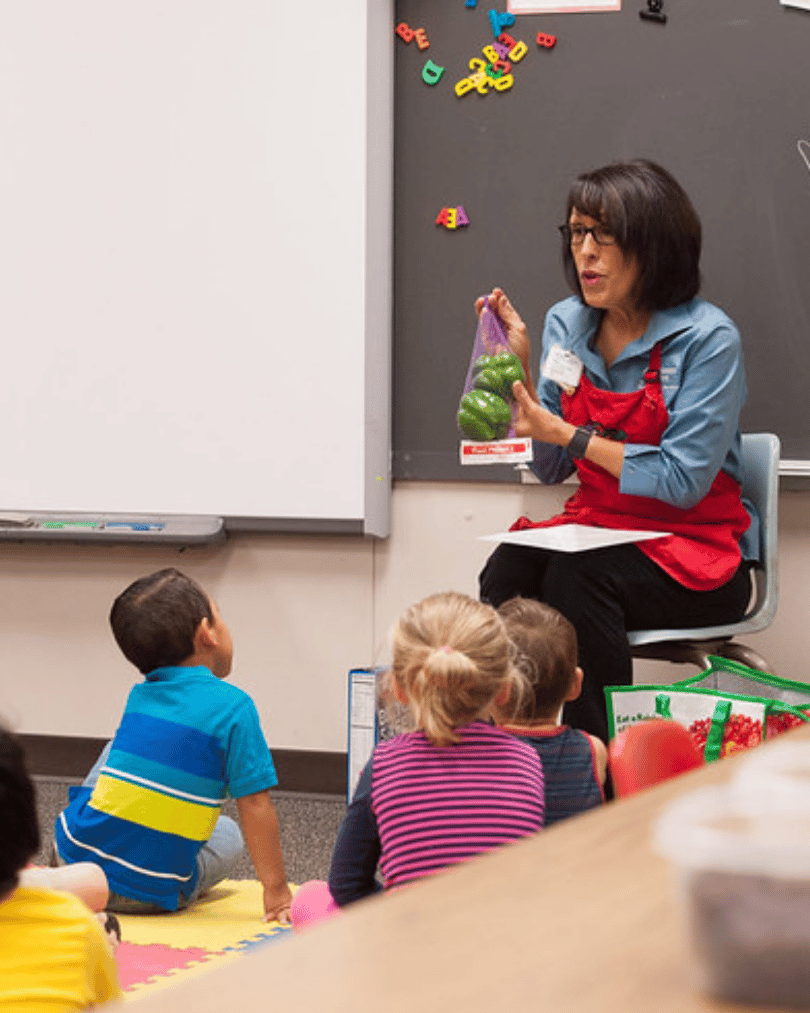 A woman teaching school kids about healthy foods, USDA