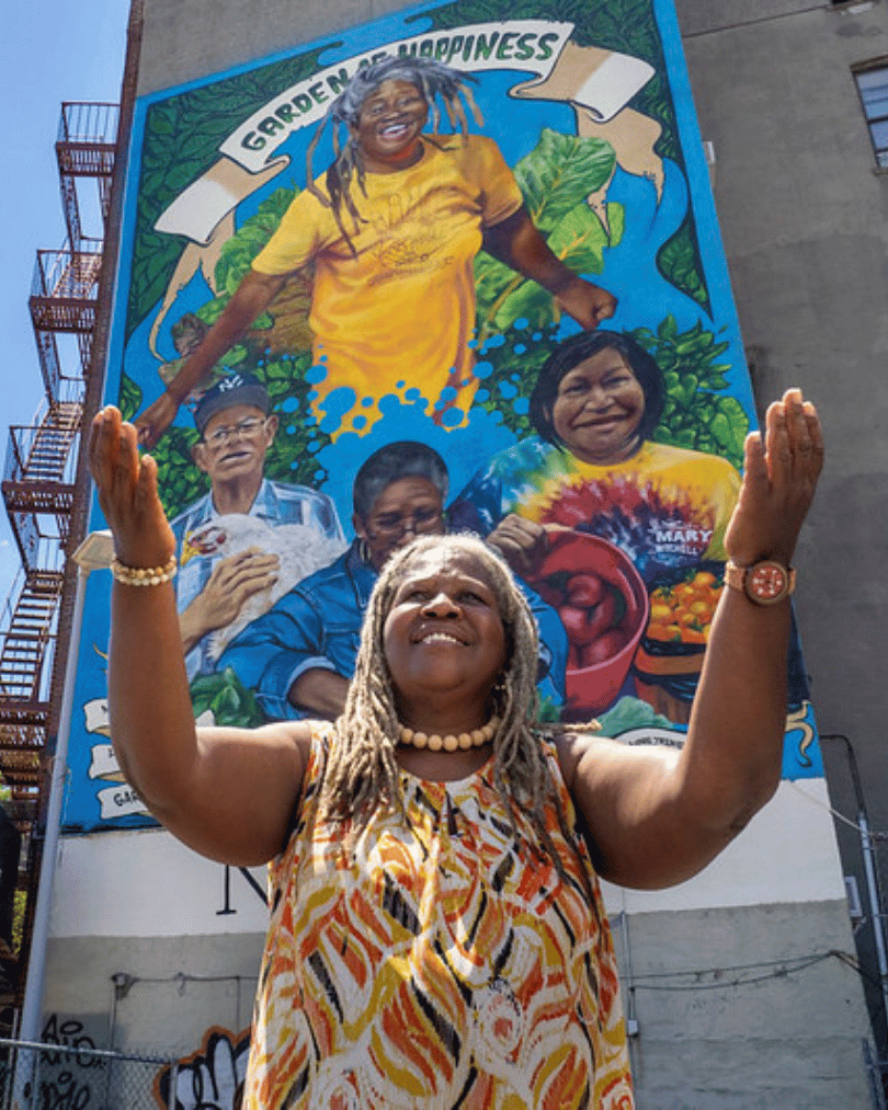 The Garden of Happiness, founder Karen Washington at her mural dedication in the Bronx in New York City is more than a natural refuge; it is a focus of community activity and cultural exchange. Members of the garden have organized voter registration drives, census outreach programs, workshops on agriculture and soil testing, as well as food drives for the homeless. (USDA/FPAC photo by Preston Keres)