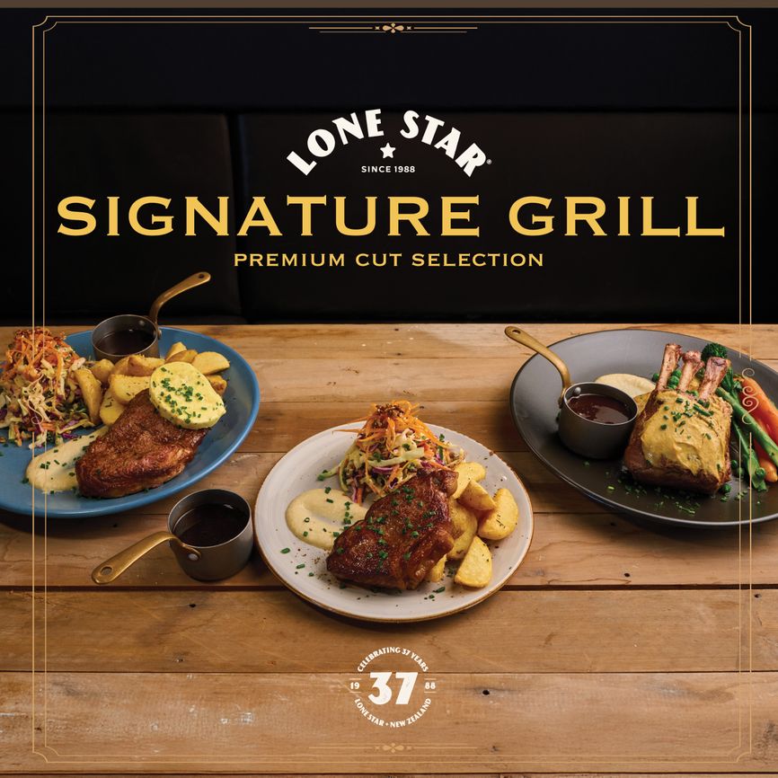 Three plates of grilled meats with sides on a wooden table, under a "Lone Star Signature Grill" sign.