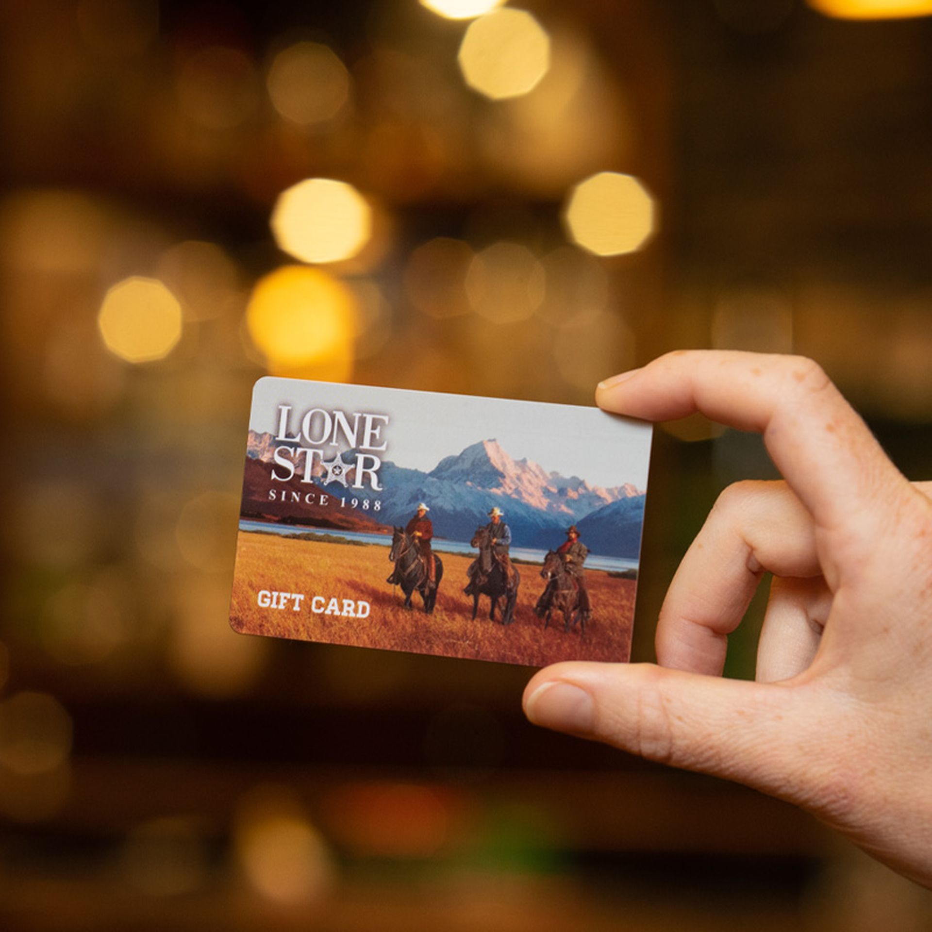 A Lone Star Gift Card in hand, the ultimate gift for food lovers and fans of classic Kiwi hospitality.