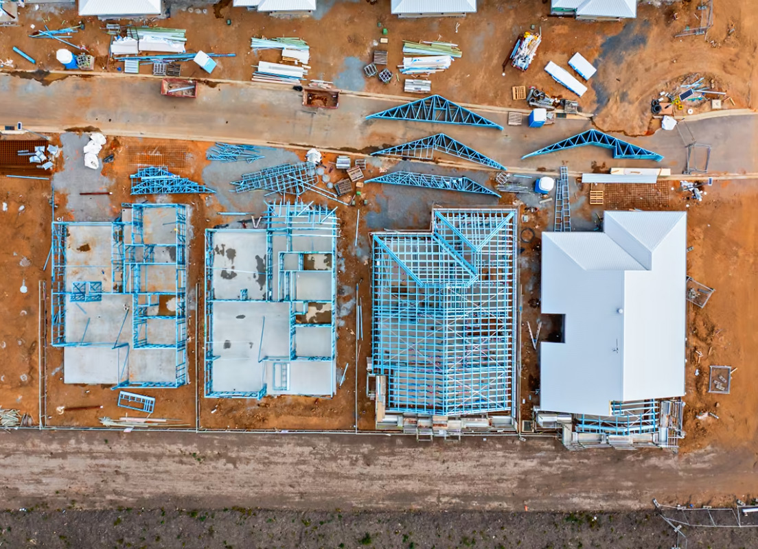Aerial view of a Allam Property Group construction site showing partially built houses, with framing made from TRUECORE steel.