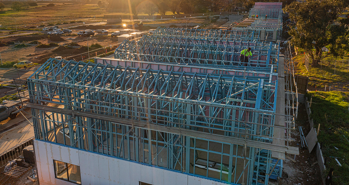 Creation Homes Hampton Park construction site at sunset with TRUECORE steel framed buildings in progress.