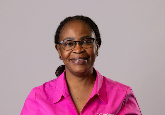 Pauline Otieno McGrath Cancer Care Nurse in pink uniform