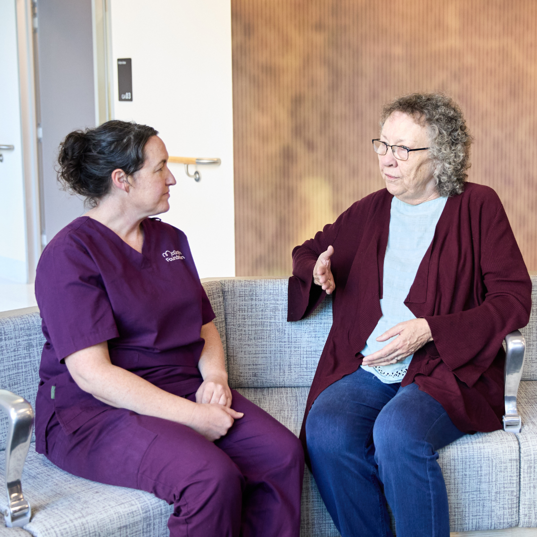 McGrath Cancer Care Nurse with patient sitting in a waiting room