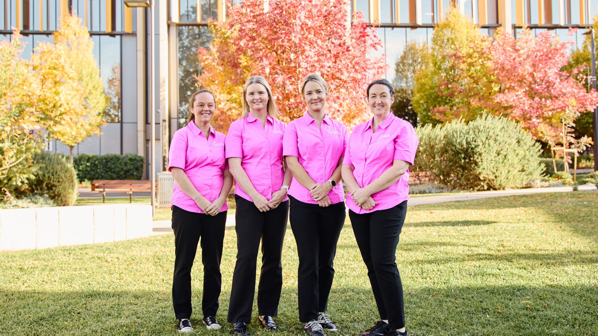 Four McGrath Cancer Care Nurses standing outside a hospital facility in their McGrath Foundation uniform