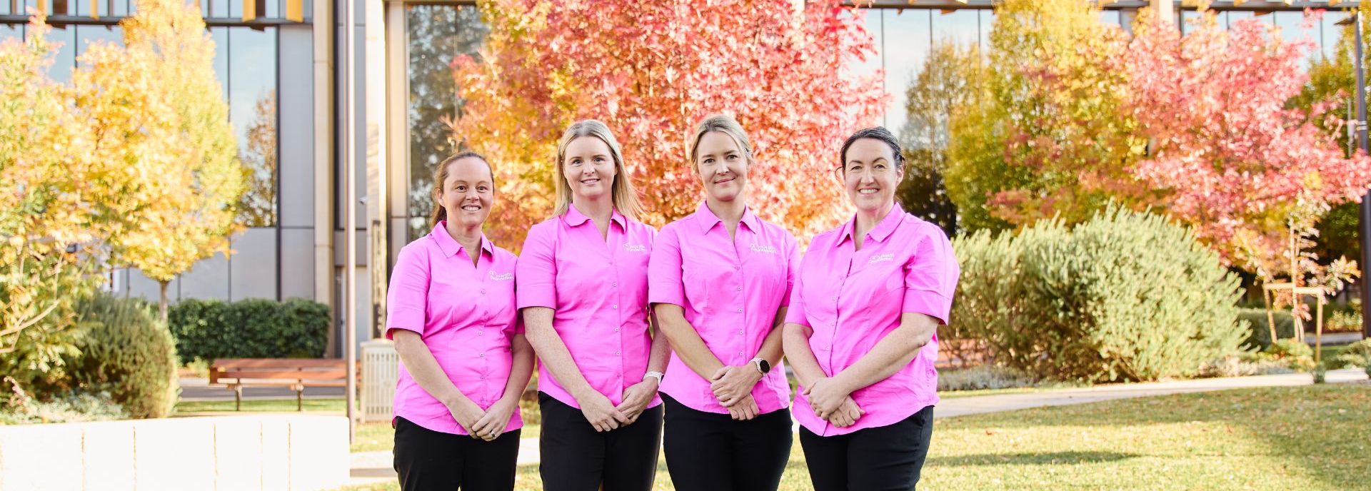 Four McGrath Cancer Care Nurses standing outside a hospital facility in their McGrath Foundation uniform