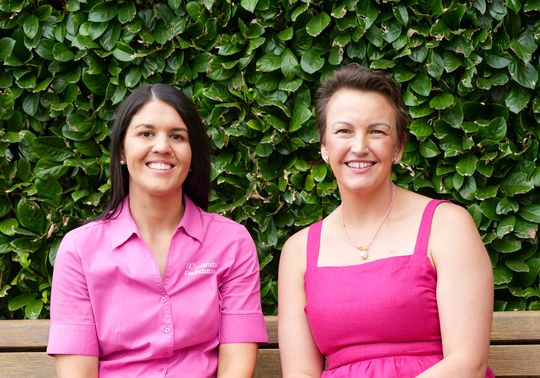 Kirby dressed in pink sitting next to her McGrath Cancer Care Nurse, Justine