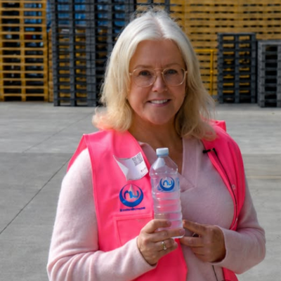 Tracy Bevan holding a bottle of Nu-Pure water