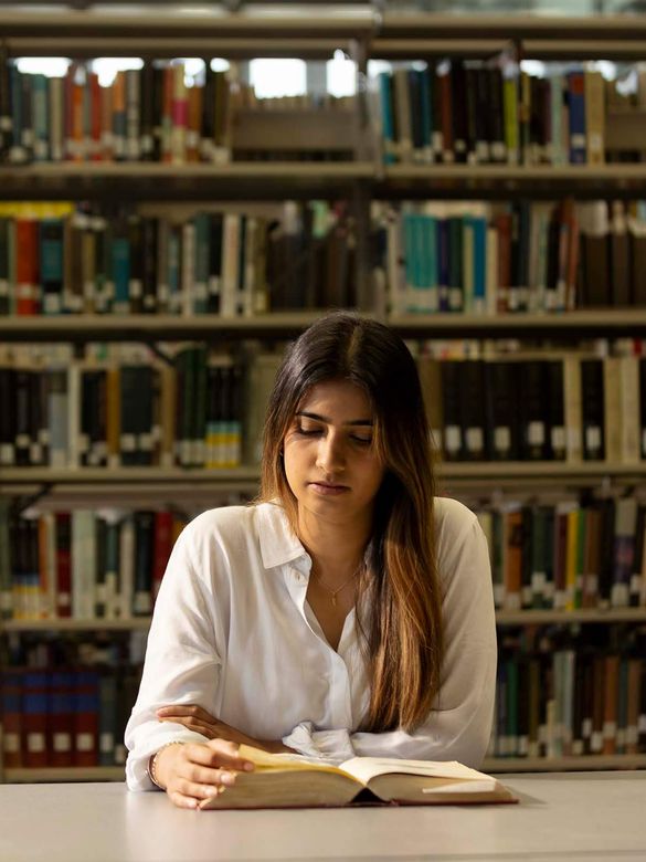 Girl studying in the library.