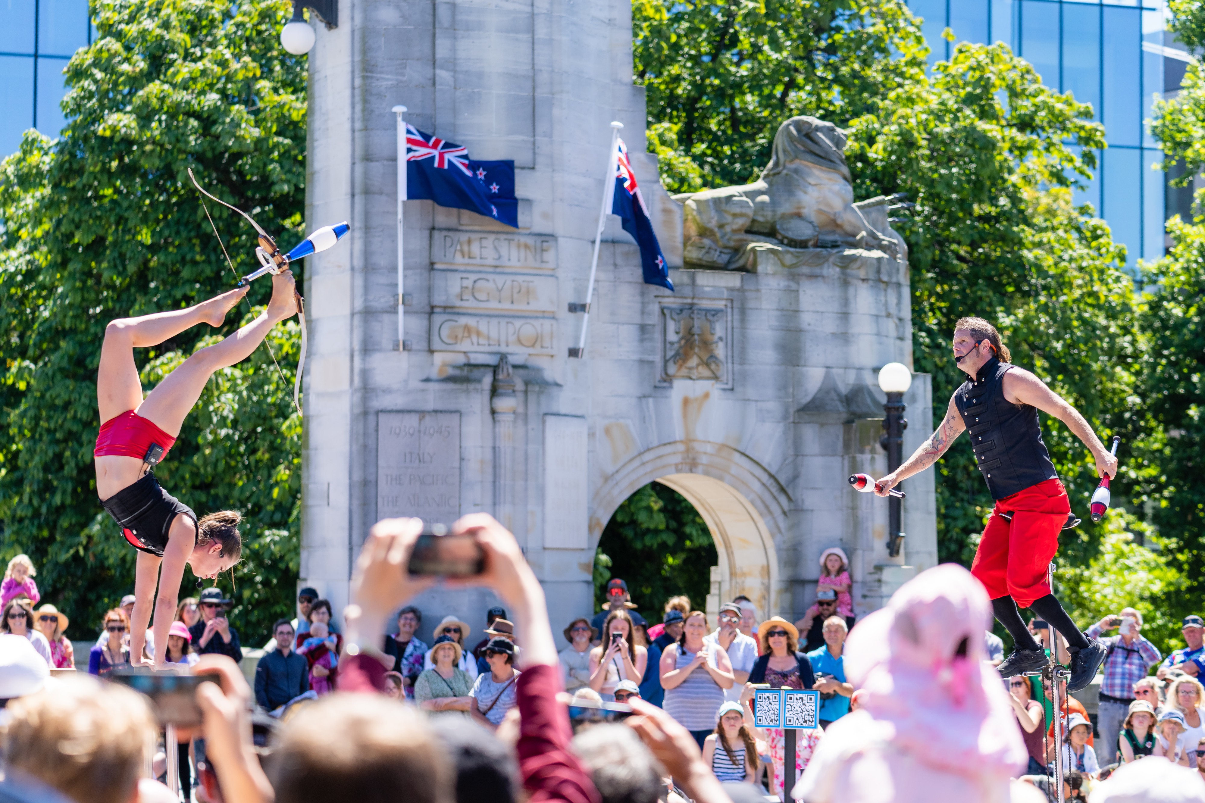 Buskers performing in front of the Bridge of Remembrance in Christchurch