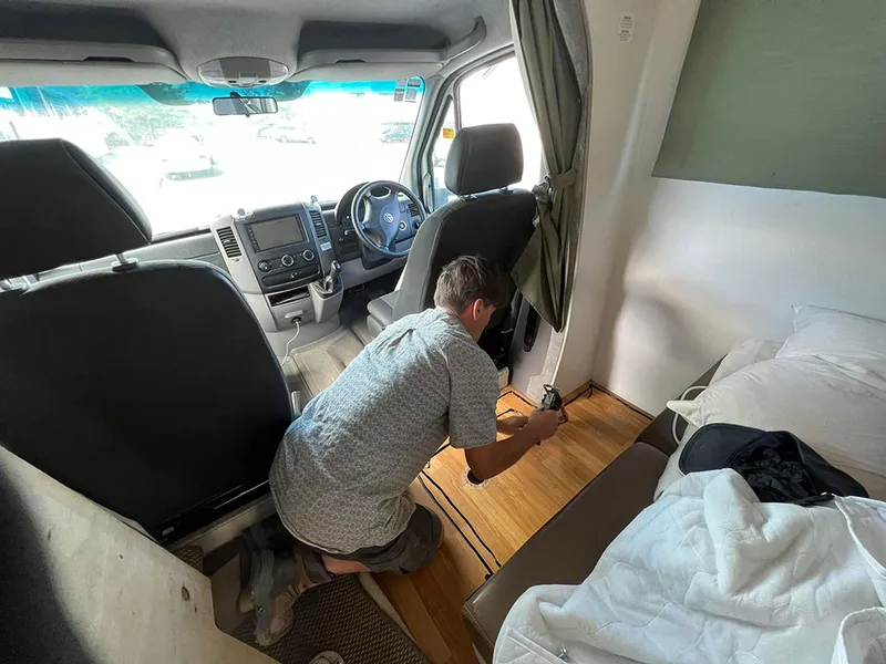 Technician fitting out the interior of a campervan