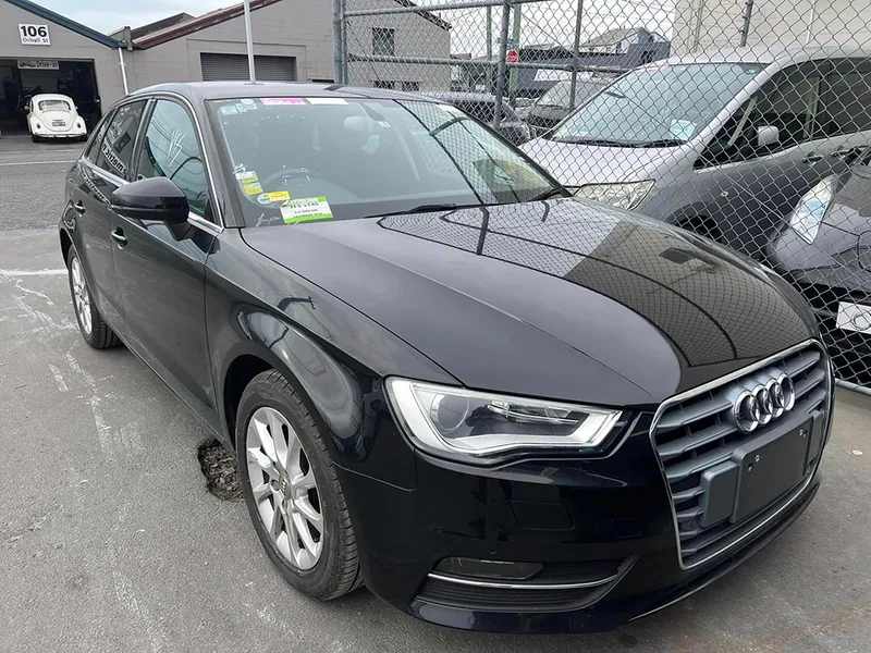 Black Audi A3 hatchback in the yard after panel and paint repair