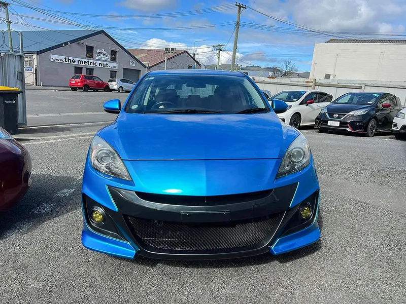 Blue Mazda 3 with a repaired and repainted front bumper