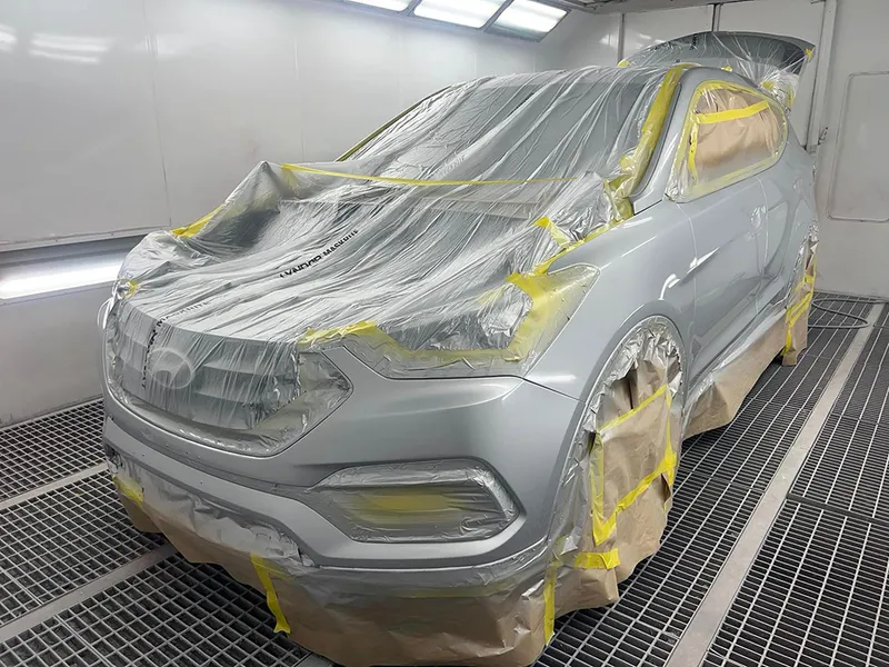 Silver Hyundai Santa Fe masked up in the spray booth for a repaint