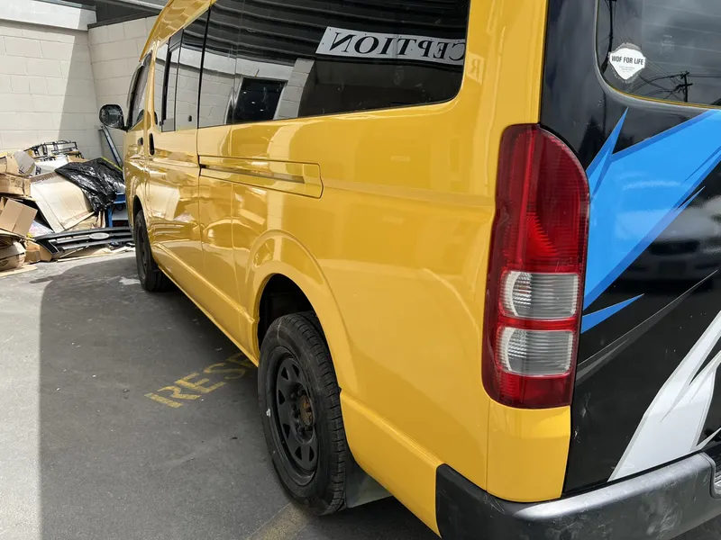 Yellow Toyota Hiace van after rear quarter panel and paint repair