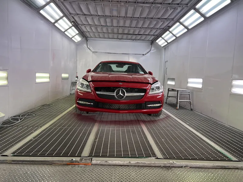 Red Mercedes-Benz roadster in the spray booth after paint repair