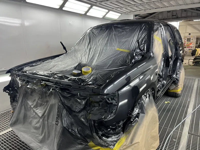 Range Rover with the front bumper removed and masked for panel repair