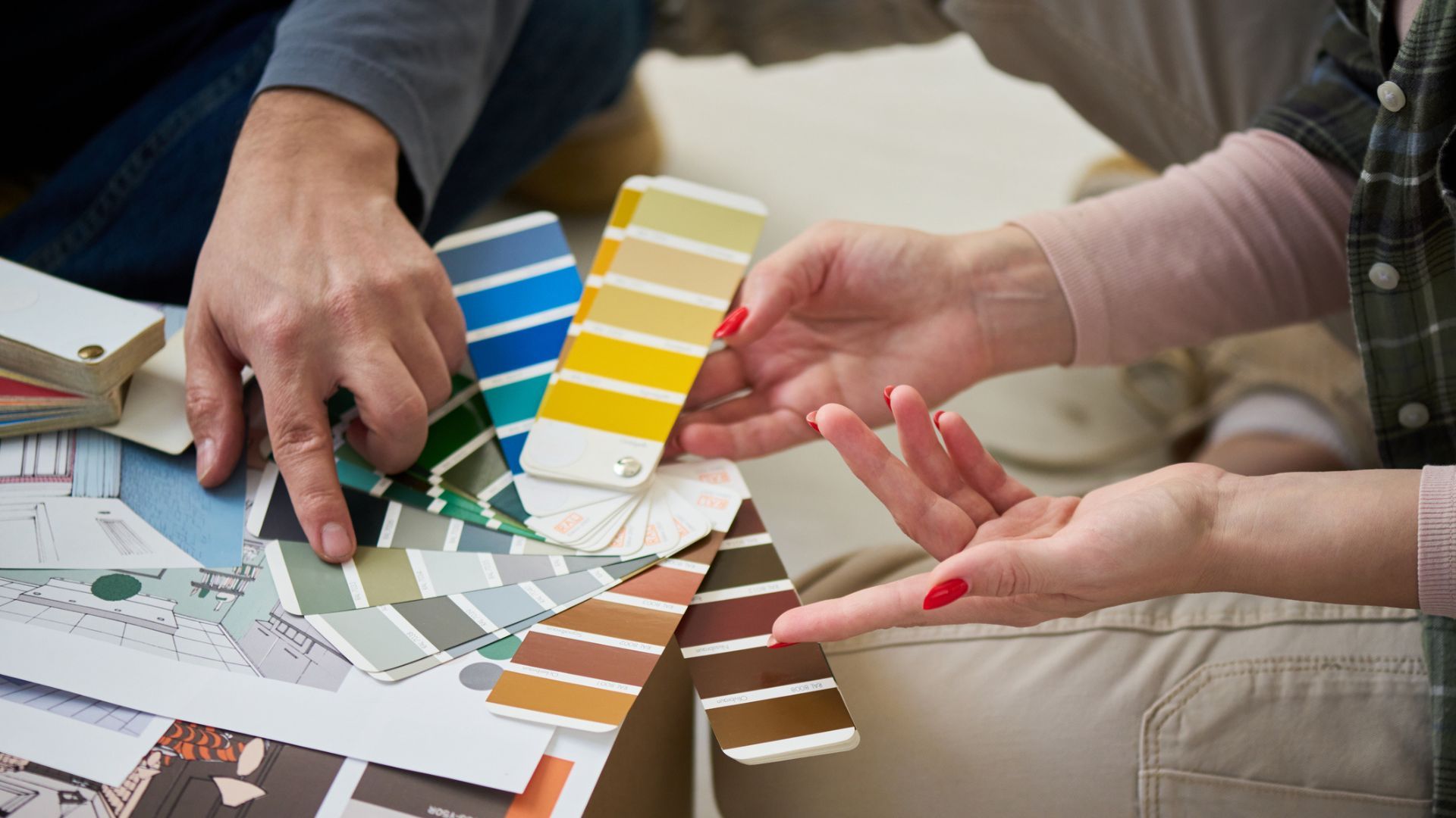 Two people going through a range of colour palettes and swatches